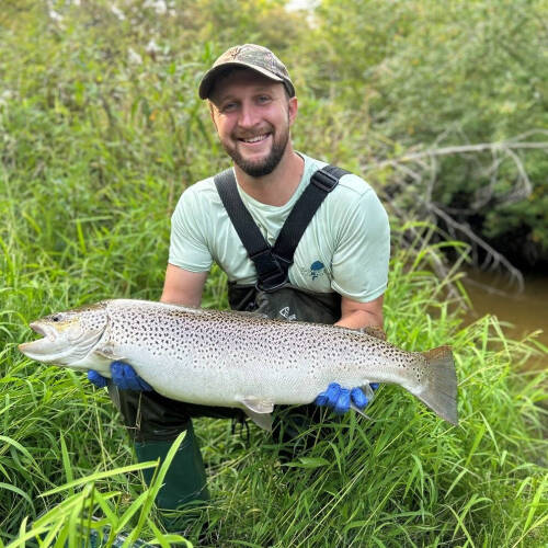 Mitchell Olszewski displays a large trout.